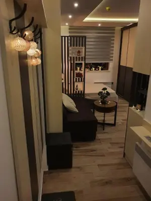 a living room with a bed and a table at Apartman Šmizla N lux - Milmari Resort in Kopaonik