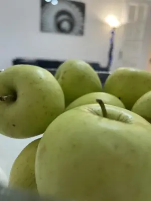 a bunch of green apples sitting on a table at Center Retro Apartment in Niš