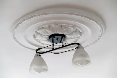 aendant light hanging from the ceiling of a room at Center Retro Apartment in Niš