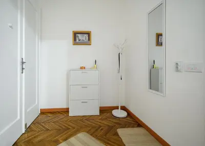 a room with a white cabinet and a mirror at Center Retro Apartment in Niš