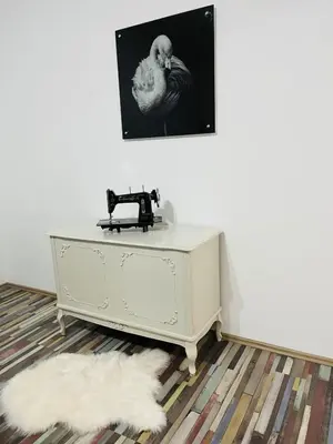 a white desk with a telephone on a wall at Center Retro Apartment in Niš