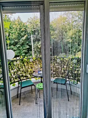 a patio with a table and chairs on a balcony at Vidikovac in Vrnjačka Banja