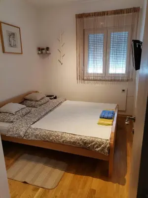a bedroom with two beds and a window at Vidikovac in Vrnjačka Banja