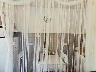 a room with white curtains in a room at Vidikovac in Vrnjačka Banja