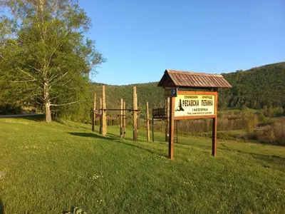 a sign in the middle of a field at Vikendica Bajka in Despotovac