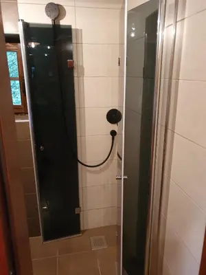 a bathroom with a shower and a mirror at Vikendica Bajka in Despotovac