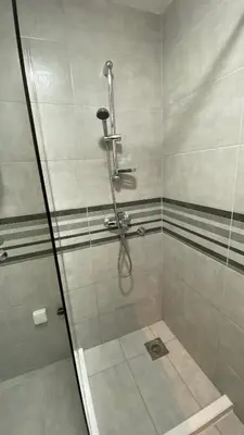 a shower with a glass door in a bathroom at Apartman Petra in Jagodina