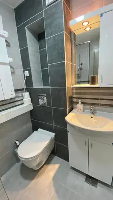 a bathroom with a toilet and a sink and a mirror at Apartman Petra in Jagodina
