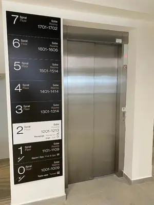 an elevator in a building with a sign on it at Apartman M&S - Zoned 2 in Kopaonik