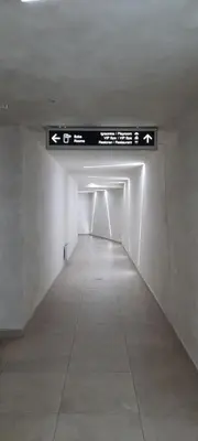 a long white hallway with a sign in a building at Apartman M&S - Zoned 2 in Kopaonik
