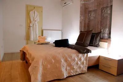 a bedroom with a bed with a laptop on it at CIRIĆ APARTMANI in Vrnjačka Banja