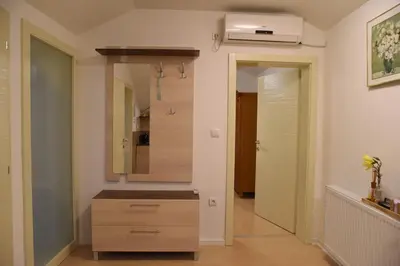 a bathroom with a sink and a mirror at CIRIĆ APARTMANI in Vrnjačka Banja