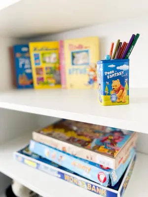 a shelf with books and a container of books at Broj jedan Delux in Soko Banja