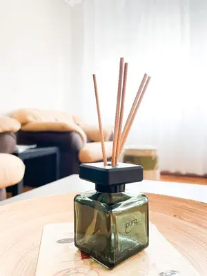a glass container with sticks in it on a table at Broj jedan Delux in Soko Banja