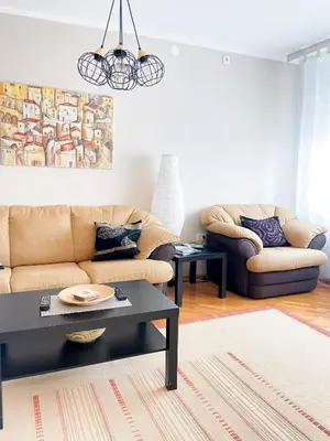 a living room with a couch and a table at Broj jedan Delux in Soko Banja