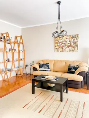 a living room with a couch and a table at Broj jedan Delux in Soko Banja
