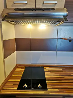 a small kitchen with a stove in a room at Jolly Kop - Apartman 4 in Kopaonik