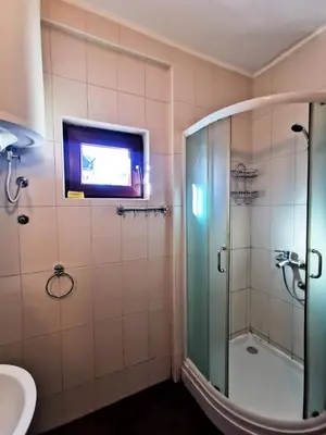 a bathroom with a shower and a sink at Jolly Kop - Apartman 4 in Kopaonik
