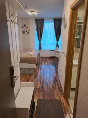 a small room with two beds and a bathroom at Lux apartmani Dunja Kopaonik Čardaci - WHITE in Kopaonik