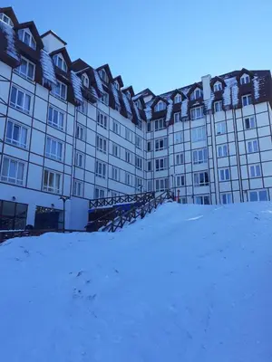 a large building with snow in front of it at Lux apartmani Dunja Kopaonik Čardaci - WHITE in Kopaonik