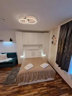 a bedroom with a bed with two towels on it at Lux apartmani Dunja Kopaonik Čardaci - WHITE in Kopaonik