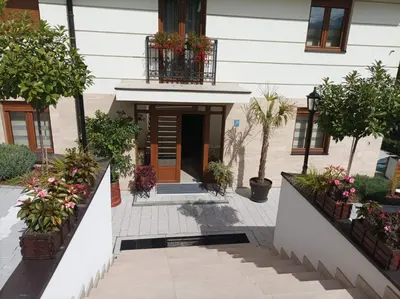 a building with a courtyard with potted plants at Apartman 8 Extra Vrnjacka Banja in Vrnjačka Banja