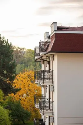 a white building with balconies on the side of it at Apartman 8 Extra Vrnjacka Banja in Vrnjačka Banja