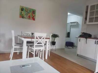 a kitchen and dining room with a table and chairs at Apartman 8 Extra Vrnjacka Banja in Vrnjačka Banja