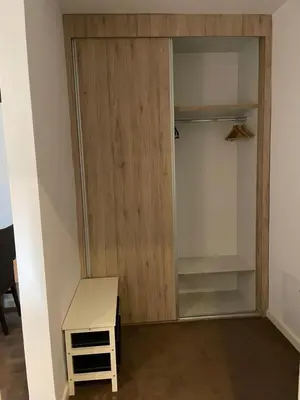 a closet with a wooden door in a room at MBC - Zupa Wellness & Spa, Kopaonik, Serbia in Kopaonik