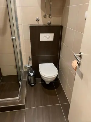 a small bathroom with a toilet and a shower at MBC - Zupa Wellness & Spa, Kopaonik, Serbia in Kopaonik