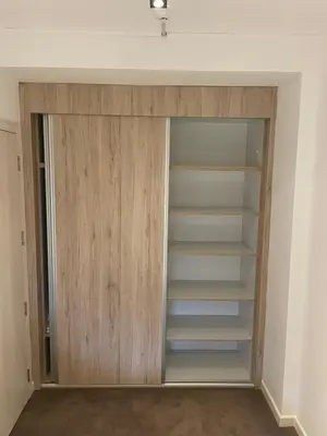 a closet with wooden doors in a room at MBC - Zupa Wellness & Spa, Kopaonik, Serbia in Kopaonik
