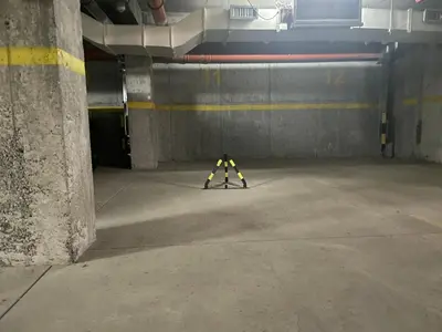 a caution sign sitting in a parking garage at MBC - Zupa Wellness & Spa, Kopaonik, Serbia in Kopaonik