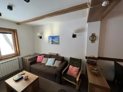 a living room with a couch and a table at MBC - Zupa Wellness & Spa, Kopaonik, Serbia in Kopaonik