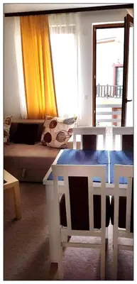 a living room with a table and a couch at Sky Apartman 202 in Kopaonik