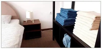 a bedroom with a bed and a mirror with towels at Sky Apartman 202 in Kopaonik