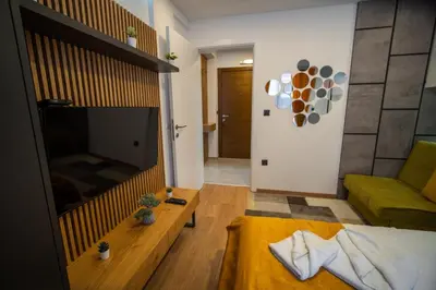 a living room with a large television and a couch at PleasureLUX MILMARI in Kopaonik