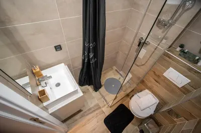 an overhead view of a bathroom with a shower and a toilet at PleasureLUX MILMARI in Kopaonik
