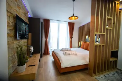 a bedroom with a bed and a large window at PleasureLUX MILMARI in Kopaonik
