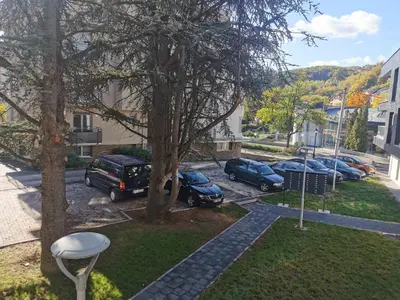 a group of cars parked in a parking lot at Apartment Ornament Lux in Vrnjačka Banja