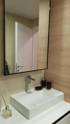 a bathroom with a white sink and a mirror at Apartment Ornament Lux in Vrnjačka Banja