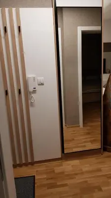 a room with a door and a hallway with a mirror at Apartment Ornament Lux in Vrnjačka Banja