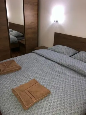 a bedroom with two beds with towels on it at Apartman Kraljevi čardaci Makica Kopaonik sa garazom in Kopaonik