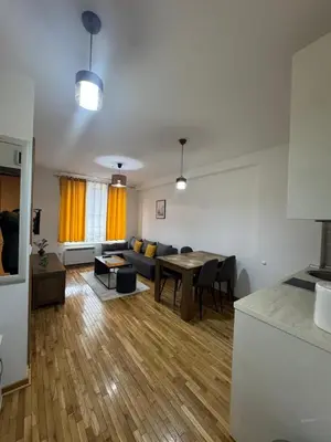 a living room with a couch and a table at Apartman Kraljevi čardaci Makica Kopaonik sa garazom in Kopaonik