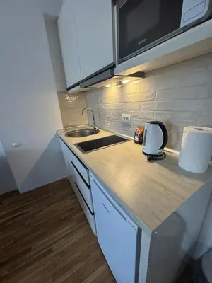 a kitchen with a sink and a counter top at Apartman Kraljevi čardaci Makica Kopaonik sa garazom in Kopaonik