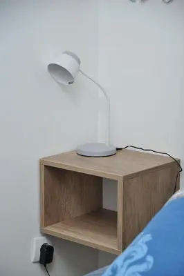 a bedside table with a lamp on top of it at Apartmani Krstojević Kopaonik in Kopaonik