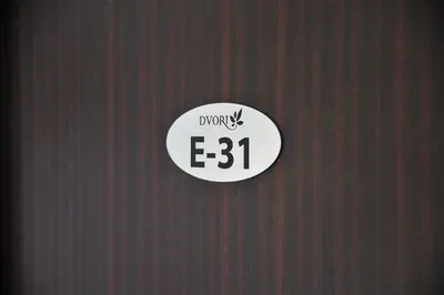 a door with a sign that reads down e at Apartmani Krstojević Kopaonik in Kopaonik