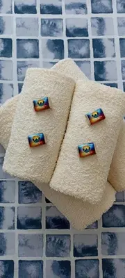 a towel with four batman pins on top of a pool at Apartman MonTanja Kopaonik, u hotelu Kraljevi Čardaci in Kopaonik