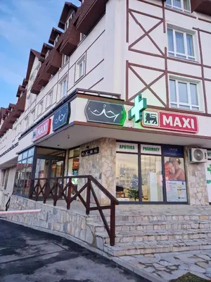 a building with a sign on the side of it at Apartman MonTanja Kopaonik, u hotelu Kraljevi Čardaci in Kopaonik