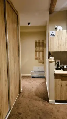 an empty room with a kitchen with a refrigerator at FEMI Kopaonik Apartment, Župa Aparthotel, Kopaonik Center in Kopaonik