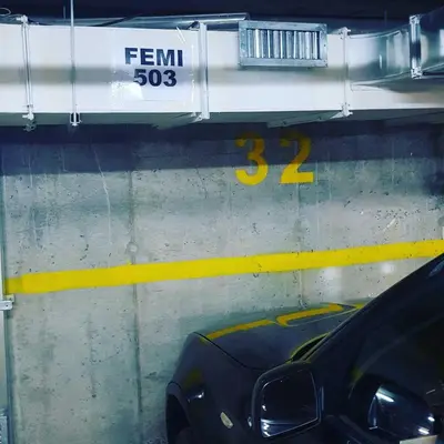a car in a parking garage with a speed limit sign at FEMI Kopaonik Apartment, Župa Aparthotel, Kopaonik Center in Kopaonik